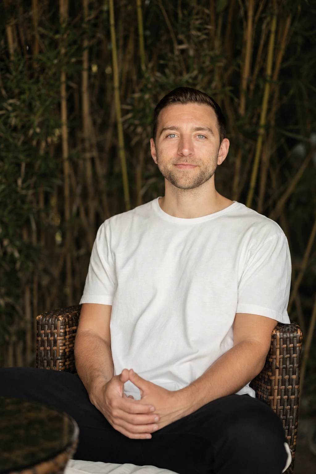 Jacob Sokol, seated in front of bamboo